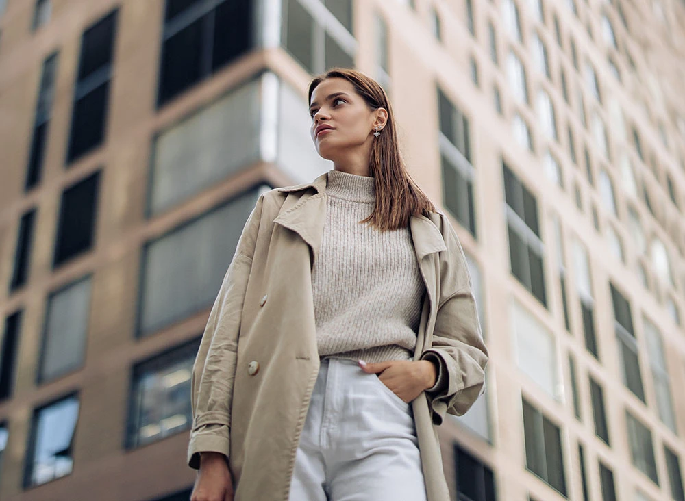 woman in a trench coat with a building in the background | Raj Dedhia MD San Francisco, CA