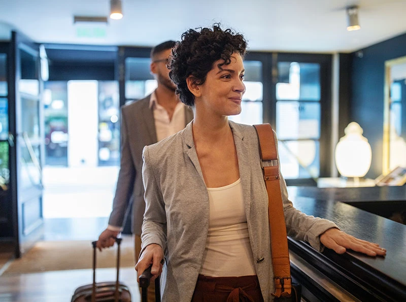 woman and man checking into hotel | Raj Dedhia MD San Francisco, CA